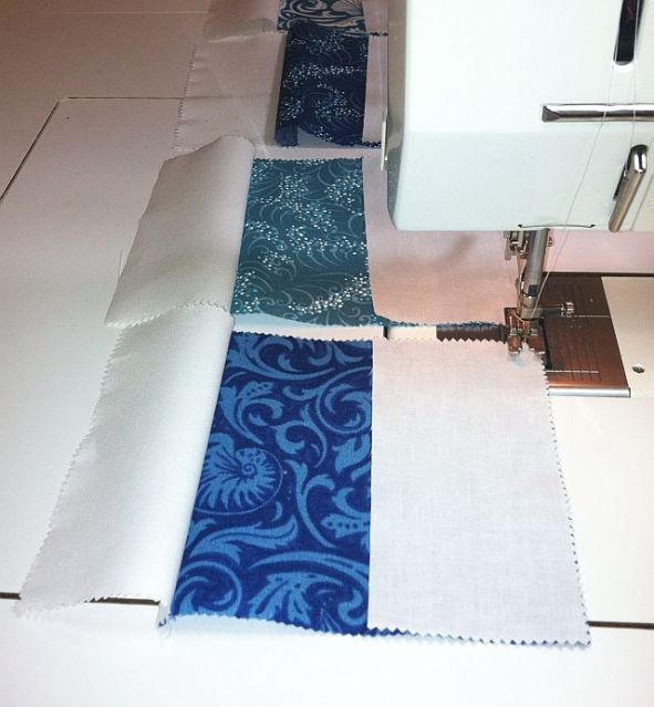 Sew white rectangles to either side of charm square.