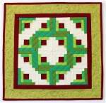 Log Cabin Wreath, Pieced and Quilted by Christa Wason 18" x 18"