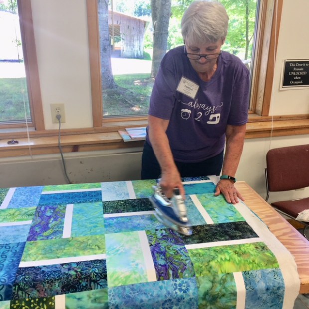 Quilt Basting - pressing the quilt
